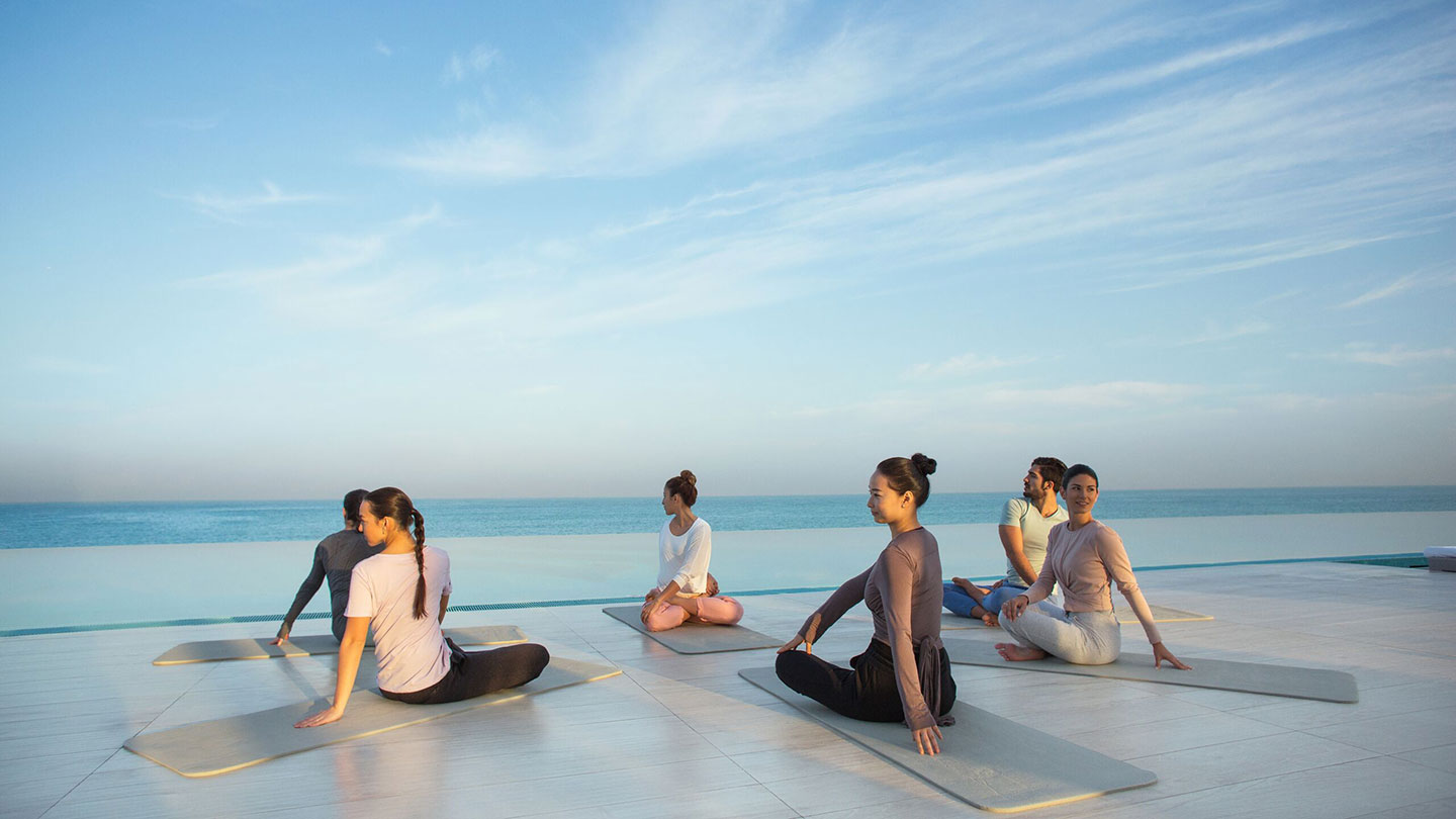 Women enjoying yoga on the beach